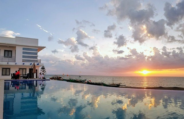 Infinity pool at sunset with the sea on the horizon